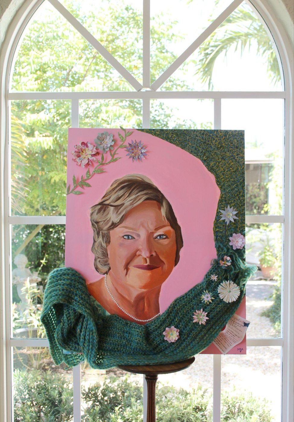 Scottie, a mixed-media portrait with knit yarn and paper flowers